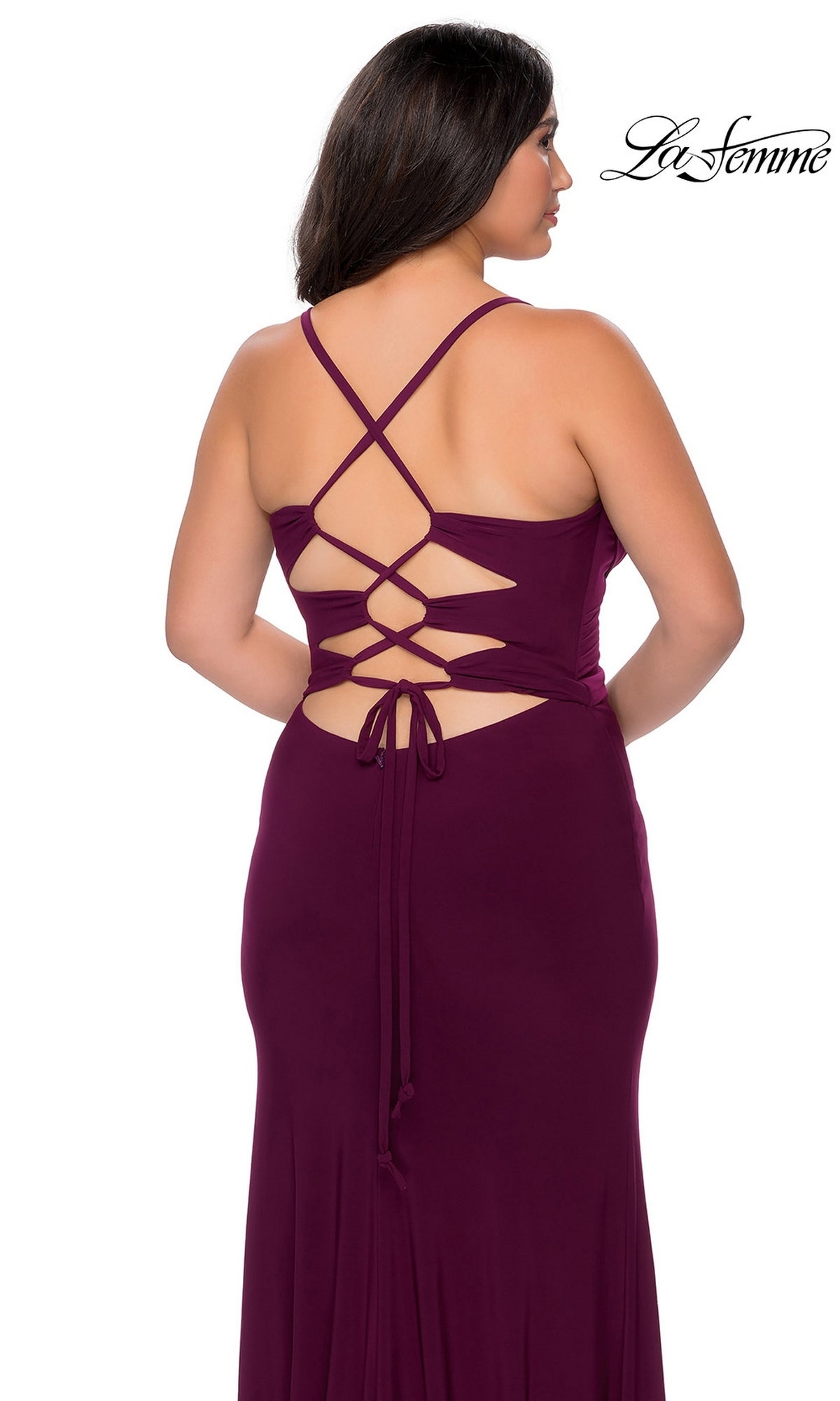 Back view of a person wearing a deep purple La Femme 29055 long plus-size prom dress with thin crisscross straps and an open lace-up back.